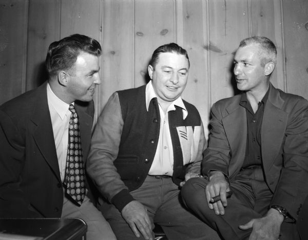 Three former NCAA boxing champions share memories from their days as boxers for the University of Wisconsin. From left are: Warren Jolleymore, Omar Crocker, and Woodrow Swancutt, with cigar.