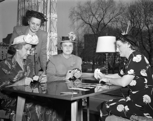 Four women who attended the dessert bridge party given by the Milwaukee Railroad Women's Club for the Northwestern Railroad Women's Club at Manchester's Madison Room. From left are: Mrs. Oscar S. (Pearl) Kline, Mrs. William F. (Catherine) Murphy, Mrs. Joseph A. (Marcella) Tomlinson, and Mrs. Edward P. (Madeline) Kingston.