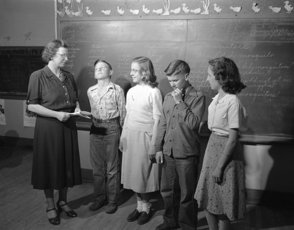 The Badger Spelling Bee at Kegonsa School, Route 1, Stoughton. Shown, left to right, are Mrs. Alvilda Orvold, teacher; and students Robert Iverson, Ann Iverson, Wayne Larsen, and Audrey Spilde.