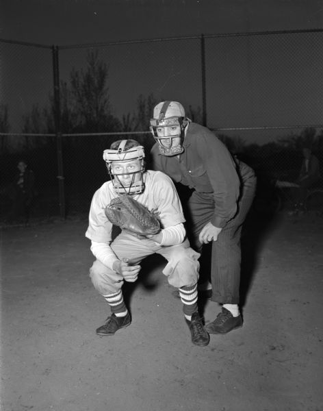 Dick Joachim, catcher for Hardy's Assembly Tavern team playing in a Monona League game with umpire Sam Caruso.