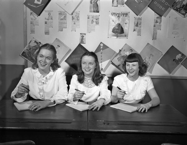 Three of the four young women students chosen to serve as the queen's court for the Madison Business College's spring formal. Seated from left to right: Arlene Anderson, Sturgeon Bay; Patricia Mousseau, 5438 Hampton Court; and Phyllis Baxter, Avoca. The fourth member, Carmen Boelting, Hazen, North Dakota, was absent when the picture was taken. The college, 215 West Washington Avenue, will hold its annual dinner and dance at the Club Chanticleer, Middleton.