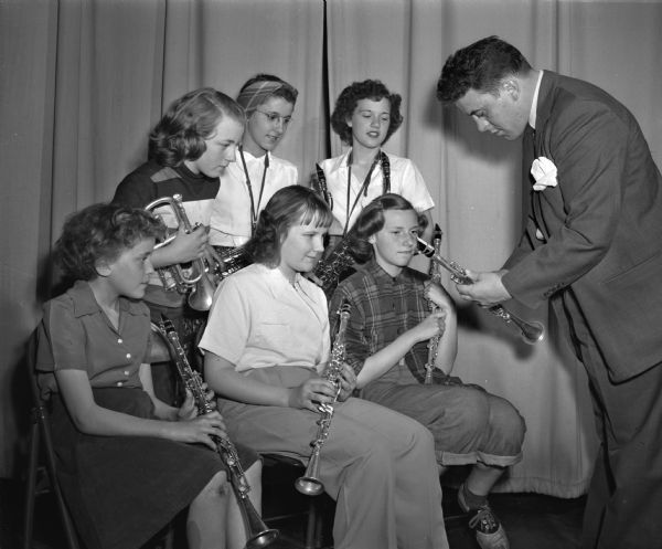 John Edwards, music director at Wonewoc high school, instructing six members of the La Valle junior high school band. Seated, from left, are Lula Mae Weidman, Sandra Booher, and Juliett Good. In the back row, left to right, are Jeanne Tomlinson, Barbara Davis, and Pat Gallagher.