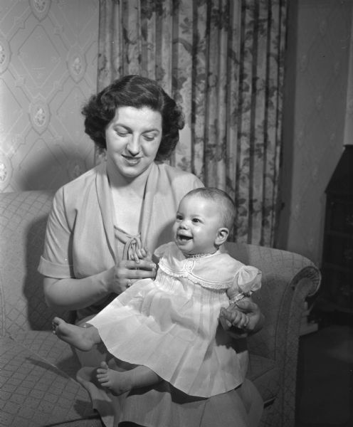 Portrait of Mrs. A. Harold (Mary Ellen) Wagner and her infant daughter, Kay Ellen. The Wagners, who live in San Francisco, California, are visiting Mrs. Wagner's parents, Mr. and Mrs. W. Weber, 1233 Sweetbriar Road.