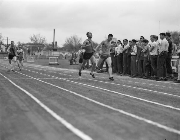 Hugh Stamps, Central High School, at the right, and West's Ronald Houser are shown as they bore down on the finish line in the 100-yard dash. Stamps won the event in 10:01 seconds, and came back to beat Houser again in another event.