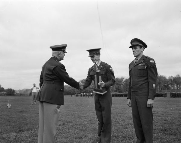 Cadet Col. William K. Chipman, Madison, was presented the commandant's award for "outstanding academic, extra-curricular, military science, and leadership qualities." Col. Julius V. Sims, commandant of Camp Ellis, Illinois and senior inspector for the federal inspection of the university ROTC, is shown congratulating Chipman.