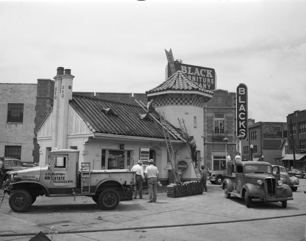 The Shell filling station, 341 State Street, as workers are starting to tear it down. The station, built in 1924 and at one time judged the second most beautiful gasoline station in the United States, will be replaced by a modern filling station with three bays. The Black Furniture Store is in the background.