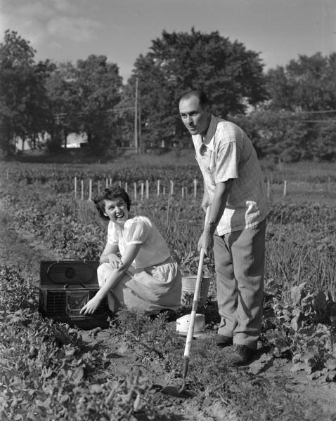 Madison Community Chest sponsored Farley tract community garden. Mr. and Mrs. Henry A. Blankenburg are listening to the radio while working in their plot.