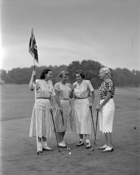 Four Maple Bluff Country Club women golfers who will participate in the Wisconsin Women's Golf Association state tournament to be held at the country club. From left are Mrs. Joseph C. (Alice) Dean, chairman of caddies; Mrs. Lindley V. (Virginia) Sprague, chairman of publicity; Mrs. R. Guy (Josephine) Martin, chairman of registration; and Mrs. Laurence W. (Virginia) Hall, head of the score recorders.