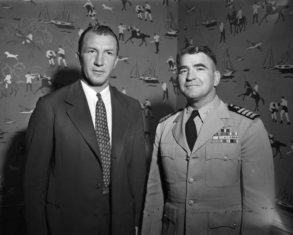 University of Wisconsin athletic director Harry Stuhldreher stands with his counterpart, Captain Howard Caldwell, at the United States Naval Academy prior to their football teams meeting in Madison.