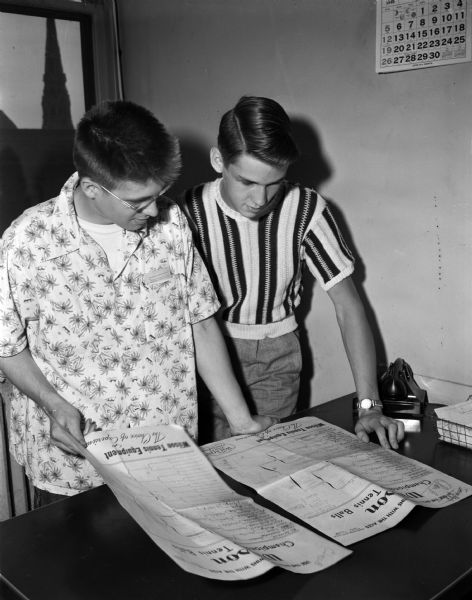 Looking over plans for a Soap Box Derby are volunteers Rolf Anderson, left, son of Mr. and Mrs. A.L.F. Anderson, DeForest, and Bobby Holm, son of Mr. and Mrs. J. Henry Holm, 459 Jean Street.