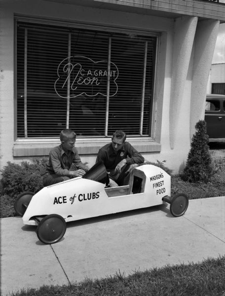 Arnold Pederson, age 13, with his Soap Box Derby racer and sponsor, Leo Welch, owner of the Ace of Clubs restaurant located at 3520 East Washington Avenue.