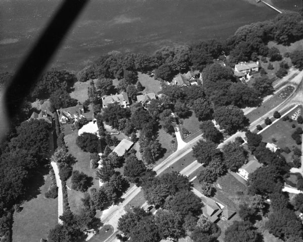 Aerial view of the residence of Mrs. George M. Fisk, 325 Lakewood Blvd., and other homes along the shore of Lake Mendota in Maple Bluff. Ida Johnson Fisk, who died February 6, 1949, was the eldest surviving member of the Johnson family which founded the Gisholt Machine Company.  She also was a founder and active member of the Attic Angel Association.  The photo was taken for the First National Bank.