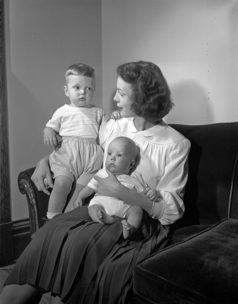 Mrs. J.F. Whitman with her two sons, James Richard and John Michael. Her husband is associated with the Cleveland Clinic in Cleveland, Ohio. They have been visiting her parents, Professor and Mrs. F.B. Hadley, 2120 Monroe Street.