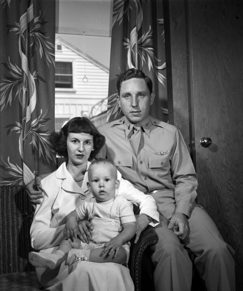 Family portrait of Lieutenant and Mrs. Leon B. (Florence) Stephens Jr. and their eleven-month old son, Timothy, who are visiting in the home of the officer's parents, Mr. and Mrs. L.B (Margery) Stephens, 579 Toepfer Avenue. Lieut. Stephens is on leave from the Army Air Force at Keesler Field, Biloxi, Mississippi. Mrs. Stephens is the former Florence Mitchell of Mineral Point.
