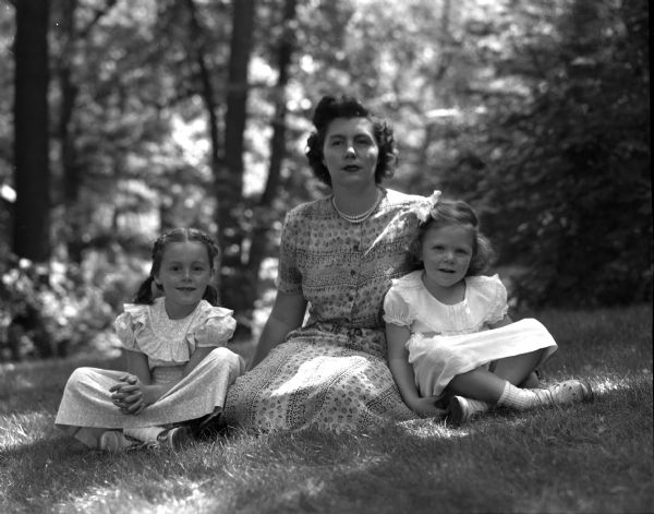 Group portrait of Mrs. Robert Hopkins and her daughters Nancy (left), age 6, and Constance, age 4, who are visiting Mr. Hopkins parents, Mr. and Mrs. Andrew W. Hopkins (Bess), 1102 Dartmouth Road, Shorewood Hills. Mrs. Hopkins and her daughters live in Long Island, New York.