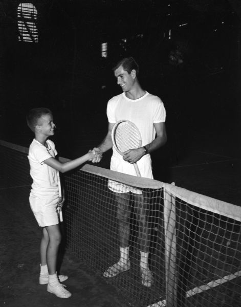 Jackie Allen, left, shakes hands with top-seeded Ted Peterson, Northwestern University, before their tennis match. Jackie, 13, is the son of Mr. and Mrs. Tracy Allen, 22 North Prospect Avenue. Jackie is one of the most promising youngsters in this area. The match was part of the Madison Open Tennis championships played at the University of Wisconsin-Madison Field House.