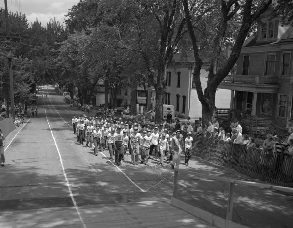 Seventy-six derby car drivers march behind leader Frankie Meyers on East Gorham Street during the Soap Box Derby Parade of Youth.