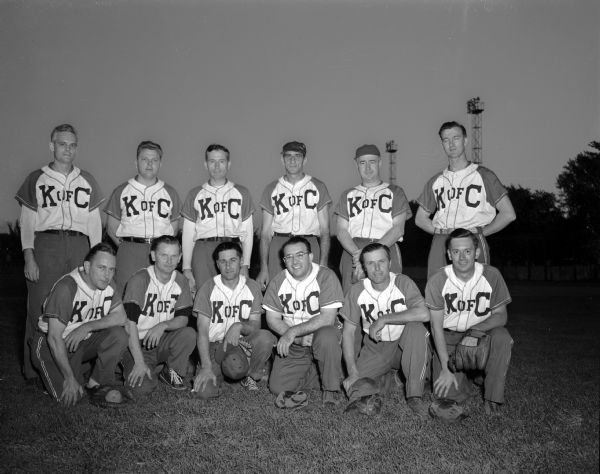 Group portrait of the Knights of Columbus softball team in uniform, losers of the annual charity ball game at Breese Stevens Field.