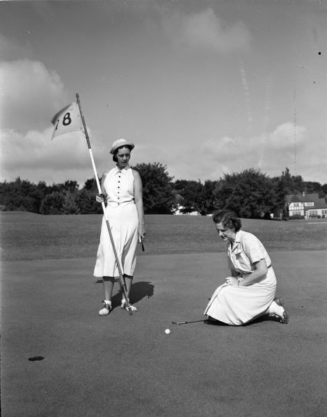 Mrs. Patrick (Bess) Lahiff (left) of 111 West Wilson Street, chairman of the tournament committee of the Nakoma Guest Day, and Mrs. Peter (Iris) Henter of 914 Beacon Street, women's golf chairman, at the 18th green at the Nakoma Golf Club.