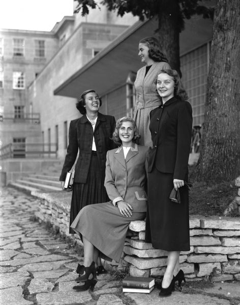 Four young women model informal clothes at the WSGA style show outside Memorial Union. Standing left to right are: Nancy Jean Maloney, daughter of Dr. and Mrs. F.G.H. Maloney, the Highlands; Jeanne Schmalz, Cincinnati, Ohio, and Jeanne O'Donnell, daughter of Mr. and Mrs. D. John O'Donnell, 415 Virginia Terrace. Seated is Sara Jean Handel, Chicago, Illinois.