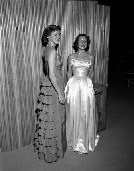 Joan Donald (left), of St. Croix Falls, and Betty O'Donnell, of St. Louis, Missouri model strapless evening gowns for the WSGA style show.