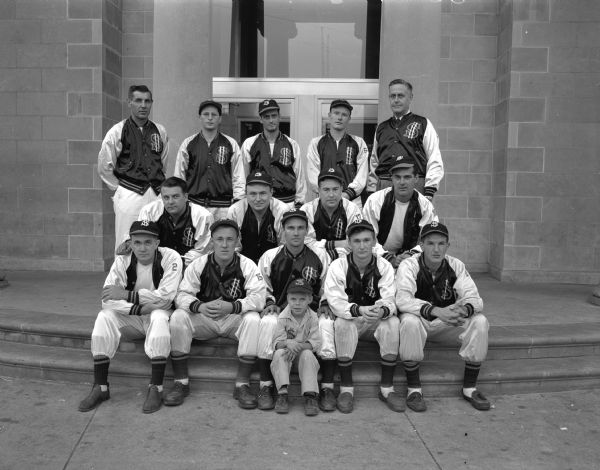 Group portrait of the Security State Bank softball team, favored to win the championship of the 23rd annual city municipal softball tournament, having already won 30 of their 34 games this season. Top row from left: Manager Francis J. Kocvara, and top row right: Ray Sennett, business manager. Batboy Paul Kocvara is seated in front.