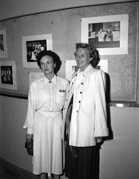 Mrs. Carl (Lola) Waller, 2138 Chamberlin Avenue, and her neighbor, Mrs. Everett F. (Elsa) Johnson, 2130 Chamberlin Avenue, posing for a portrait while attending the Wisconsin Players' production of "The Philadelphia Story" at the Wisconsin Union Theatre.