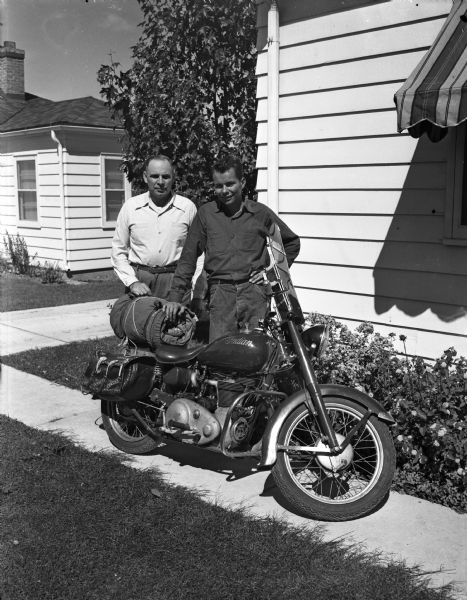 Bob Schuman (right), 16 year old son of Lieutenant Myron W. and Mabel Schuman,  returned from a 6,700 mile motorcycle trip to the Pacific Coast and back. He rode his one-cylinder Indian motorcycle for the trip.  His father, Myron, is with the Madison police department.