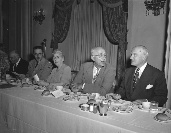 Attendees of the Phi Beta Kappa National Council Banquet sit behind a clothed table at the Hotel Loraine.  C. A. Dykstra, former University of Wisconsin president, and now provost of the University of California at Los Angeles, is pictured with Raymond Waters, president of the University of Cincinnati, at the banquet.