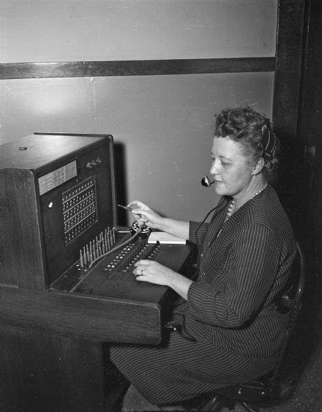 Mrs. Rose E. Amoth works at the new police telephone switchboard at the police station, 14 South Webster Street.