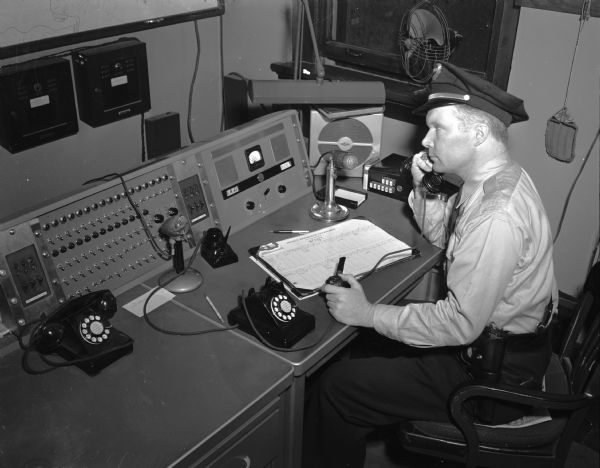A Madison police officer at the new police telephone switchboard at the police station, 14 South Webster Street.