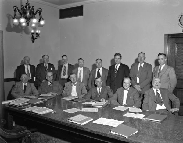 The new legislative council for the 1949 legislative session. Front row, left to right, are: Assemblyman Alex Nicol (R-Sparta), Senator Jess Miller (R-Richland Center), Senator William Schmidt (D-Milwaukee), Assemblyman Alfred Ludvigsen (R-Hartland), chairman, Senator Melvin Laird (R-Marshfield), vice-chairman, and Assemblyman Raymond Peabody (R-Milltown). Back row, left to right, are: Assemblyman Burger Engebretson (R-Beloit), Senator Frank Panzer (R-Oakfield), Assemblyman William Clark (R-Vesper), Assemblyman Milton Burmaster (R-Wauwatosa), Assemblyman George  Molinaro (D-Kenosha), Senator Warren Knowles (R-New Richmond), and Assemblyman Vernon Thomson (R-Richland Center), secretary. Both Knowles and Thomson would go on to be elected governor; Laird would become a congressman and secretary of defense.