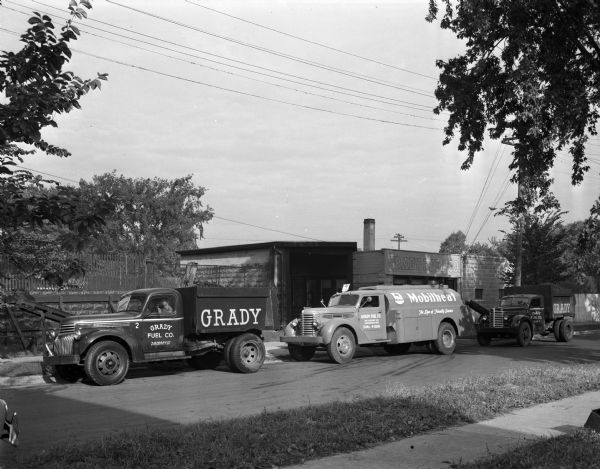 The Grady Fuel Company, 218 Corry Street, buildings, with the company trucks parked on the street.