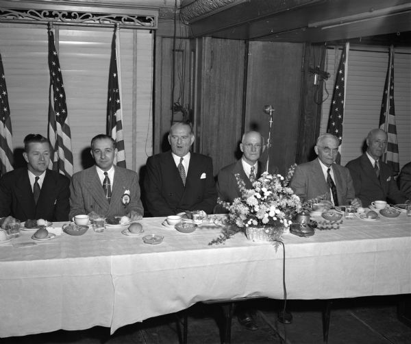 Guests sitting at the head table at the Madison Lions Club Constitution Day Luncheon at the Park Hotel. Left to right are Rev. Charles R. Bell, Jr., pastor of the First Baptist Church; Attorney Maurice B. Pasch, general chairman of the event; State representative Frank B. Keefe, Oshkosh, the main speaker; Frank B. Swoboda, Lions Club president; Chief Justice Marvin B. Rosenberry, of the Wisconsin Supreme Court; and Joseph W. Jackson, executive secretary of the Madison and Wisconsin foundation.