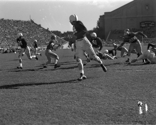 University of Wisconsin vs. Marquette football game. Jim Embach, Wisconsin No. 41; Joe Kelly, Wisconsin No. 54; Vic Wojoik, Marquette No. 40 and Bob Ottoson, Marquette No. 65.