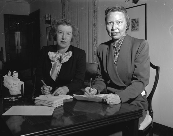 Dorothy J. Frautschi (left), 31 Paget Road, and Louise Benner, 21 Old Shore Road, addressing envelopes for the Children's Service Society's annual membership tea.