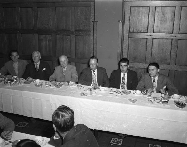 Men sitting at the speakers table at a dinner given in honor of service mechanics of area Chevrolet dealers at the Park Hotel. Left to right: Donald F. Knowles, department manager, Capital Garage, Inc; Harry G. Messer, Janesville, Chevrolet zone manager; K.F. Kogelmann, treasurer, Capital garage; J.W. Campbell, Janesville, zone service manager; G.T. Schowalter, Madison, district Chevrolet manager; and B.G. Alaman, Madison, district parts and accessories representative.