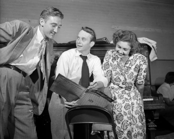 Richard T. Spitler, Battle Creek, Michigan, professional director of the JCC revue, center, discusses a dance routine with Bill Graham, Route 2, left, and Mrs. Jack (Maureen) Donis, 552 West Mifflin Street, who will do a solo and dance in the revue. Mr. Graham is general manager of the production.