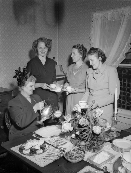 Four ladies attending a League of Women Voters coffee at the home of Mrs. A.T. (Daisy) Breyer, 2730 Lakeland Avenue. From left are :Mrs. Leon (Dorothy) Kelley, Mrs. George (Mary) Reinke, Mrs. George (Grace) Chatterton, and hostess Daisy Breyer.