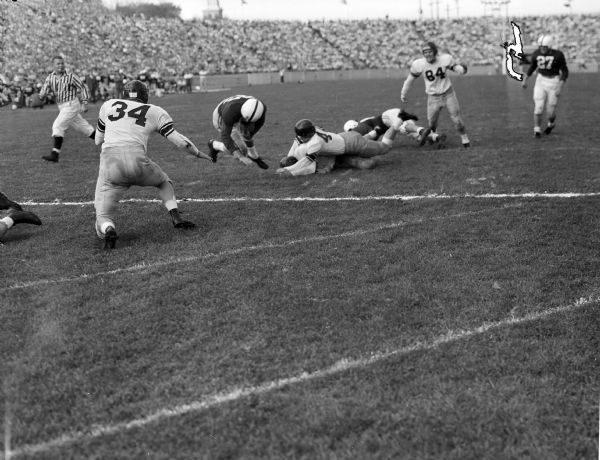 Action shot during the first quarter of the Wisconsin vs. California football game at Camp Randall Stadium. Wisconsin's Lisle Blackbourn, #33, is crossing the goal line to score a touchdown.