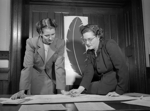 Gertrude Adams (right), chairman of the women's division of the Community Chest campaign, confers with her associate chairman, Mary Lobb, about final plans for the house-to-house solicitation.
