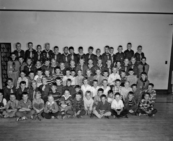 A group portrait of Cub Scout Pack 230 at Dudgeon School that welcomed forty-three new "Bobcats" to the membership. The cubmaster is Win Guenther.