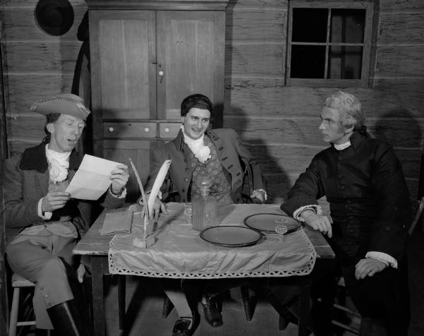 Three actors in costume, portraying pre-Revolutionary New England characters in the drama, "The Devil's Disciple" by George Bernard Shaw. The actors, part of the Wisconsin Players, University of Wisconsin theatre group, include Fred Thompson, Bruce Kanitz and Robert Couture.