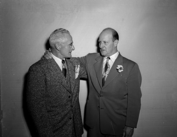 Rollie Williams, Asst. Athletic Director at the University of Iowa, left, and Guy Sundt, who was being honored for his 25 years of service as a member of the University of Wisconsin athletic staff. The two men had played together on the 1920 U.W. football team, when the team lost only one game.