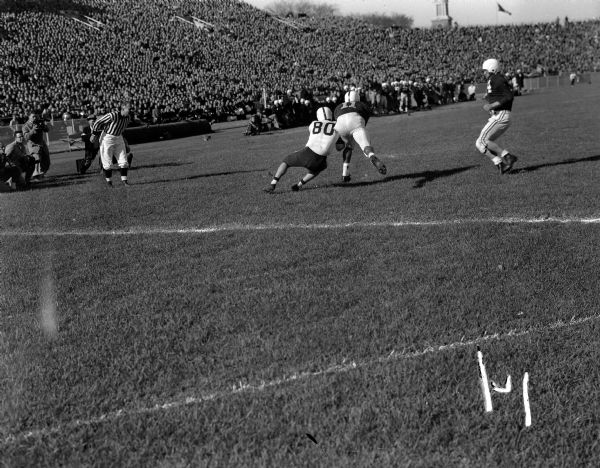 UW halfback Ed Withers (#11) fails to break up a Buckeye pass received by Buckeye end James Hague (#80) during the Wisconsin vs. Ohio State Football Game.
