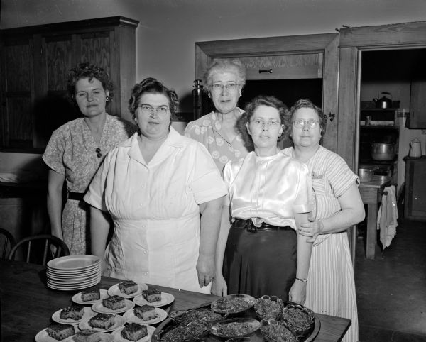 Workers who planned, prepared, and served the kick-off luncheon for Community Chest workers in the guild hall at Grace Episcopal Church. From left to right are Mrs. Clem Hegge of Waunakee, Mrs. Theresa Daniels, Mrs. Arnold (Charlotte) Rasmussen, Mrs. Thomas W. (Mabel) Mills, who is a former fraternity cook and person in charge of four Community Chest luncheons, and Mrs. Margaret Landen.