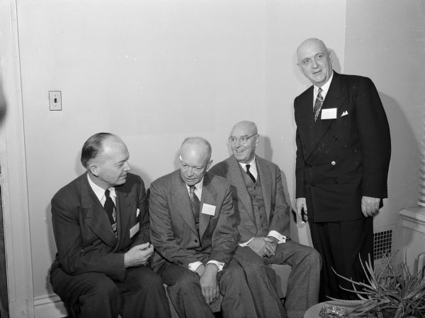 Pictured at a meeting of the American Association of Universities are (seated, from left): Harold B. Stassen, president, University of Pennsylvania; Dwight D. Eisenhower, president, Columbia University; and Henry Wriston, president, Brown university. Standing next to Wriston is an unidentifed man.