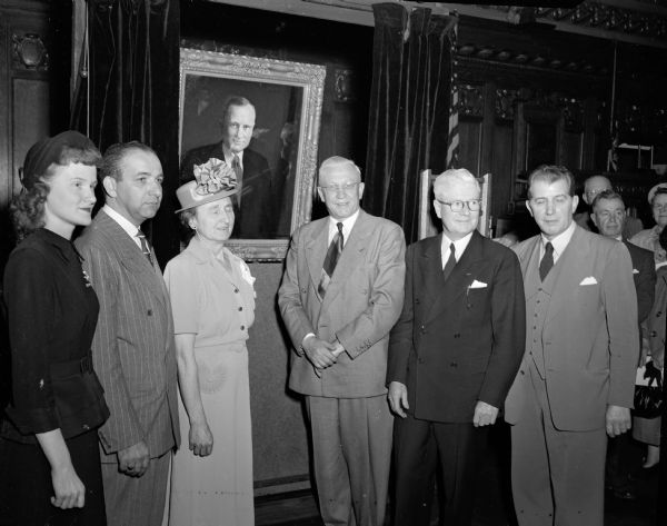 Standing before the portrait of the late Governor Elect Orland S. Loomis, presented to the State in the assembly chambers, are (from left) Laura Jean Loomis, who unveiled the portrait of her father, Attorney Maurice B. Pasch, Mrs. Loomis, Governor Rennebohm, Philip R. La Follette, and Christian Abrahamsen, Chicago artist."  Governor Elect Orland S. Loomis was born November 2, 1893 and died December 7, 1942, prior to his inauguration.
