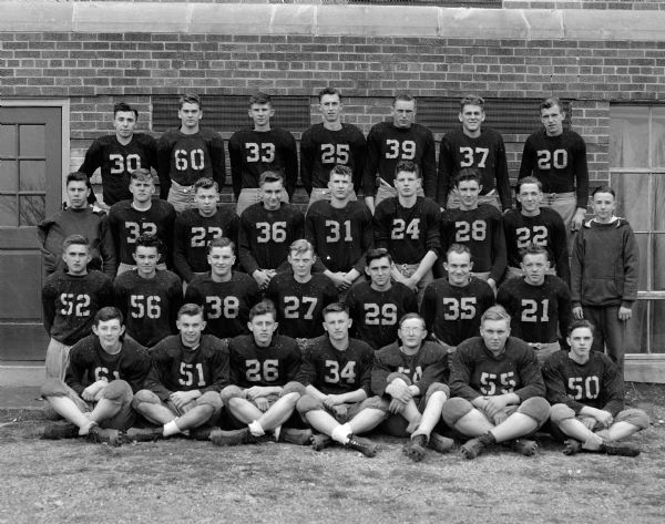 Group portrait of the Sun Prairie High School football team, Madison Suburban League football champions. Their coach is Francis Sheehan.