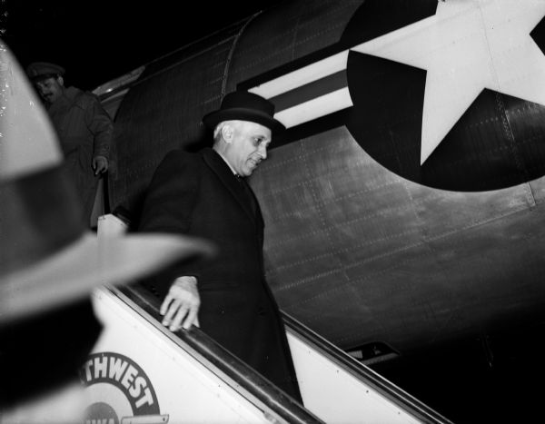 Prime Minister Pandit Jawaharlal Nehru of India decending the stairs from an airplane at Truax Field. Nehru came to Madison to speak at the University of Wisconsin.